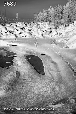 7689 snowy rocky shoreline with Meridian Bridge V #2