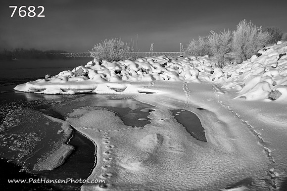 7682 snowy rocky shoreline with Meridian Bridge H #1